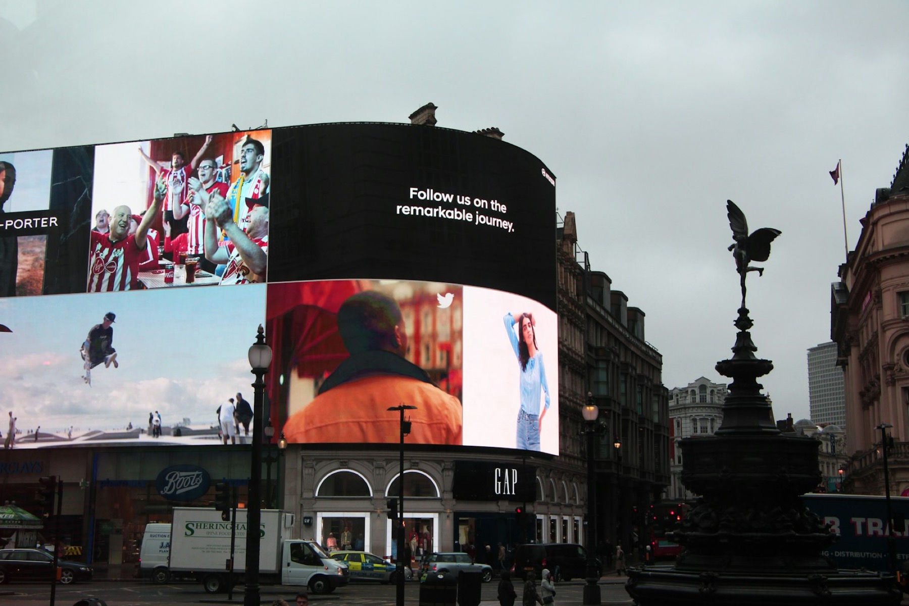 Digital billboards above a busy street corner