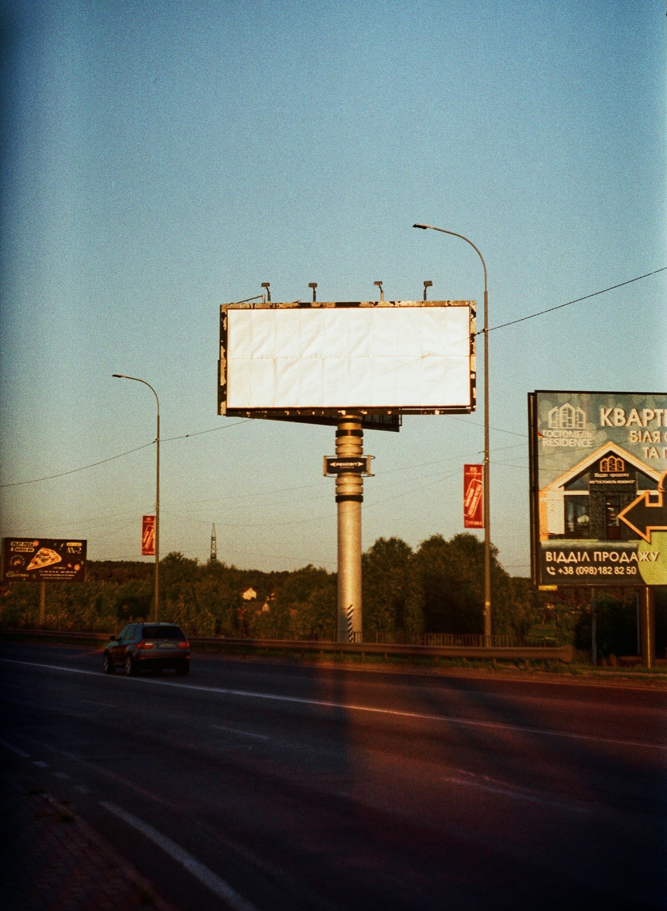 Billboard above a city street at dusk